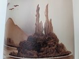 a vase with a picture of a desert scene on it