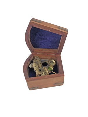 a small wooden box with a brass object inside of it