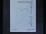 a framed photograph of a drawing of a woman ' s face with a heart on it