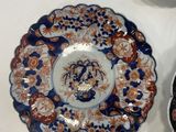 three plates with different designs on them on a white surface