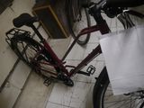 a red bike with a white bag on the back of it