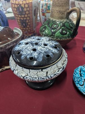 many different vases on a table with a red table cloth