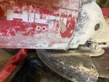 a close up of a person using a circular saw to cut a piece of wood