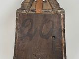 an old wooden box with a piece of wood sticking out of it