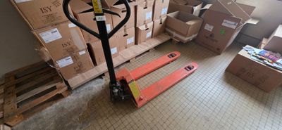a fork lift in the middle of a room filled with boxes