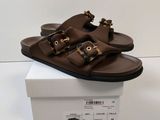 men ' s brown leather sandals with buckles on top of a white box