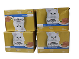 four boxes of gourmet cat food stacked on top of each other
