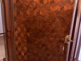 a wooden cabinet with a marble top in a room