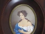 a picture of a woman in a blue dress on a clock