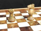 two chess pieces on a chess board with a black background