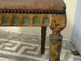 a small wooden bench with a brown seat on a tiled floor