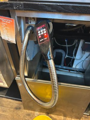 a cup of coffee sitting on a table next to a machine
