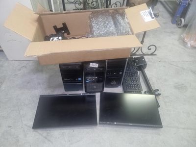 two laptops and a keyboard in a box on the floor