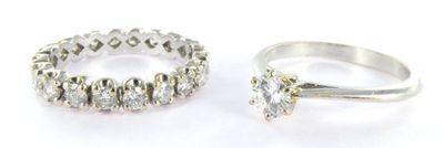 two silver rings sitting next to each other on a white surface