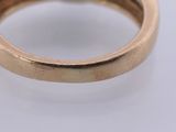 a close up of a gold ring with a diamond in the center