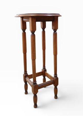 an image of a small wooden table with two legs and a round top