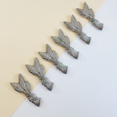 six silver metal birds on a white and yellow background