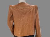an image of a mannequin mannequin wearing a brown leather jacket