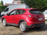a red mazda cx - 5 parked in a parking lot