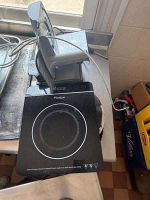 a black speaker sitting on top of a counter next to a window