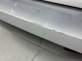 a close up of a car ' s bumper with scratches on it