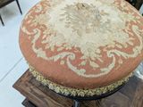 a small stool with a cushion on top of it