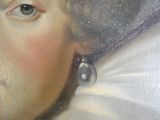 un gros plan sur un tableau représentant une femme portant une boucle d'oreille en perle