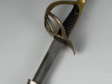 an old sword with a metal handle on a white surface