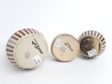 two old baseballs sitting next to each other on a white surface