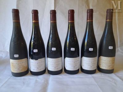 six bottles of wine are lined up in a row on a table