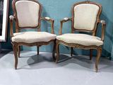 two chairs sitting next to each other in a room