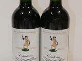 two bottles of wine that are sitting on a table