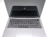 a close up of a laptop computer on a white surface
