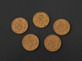 four gold coins are arranged in a circle on a black surface