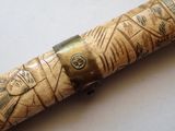 a wooden pen with a design on it sitting on a table