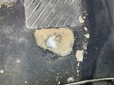a dirty floor in a car with dirt on it