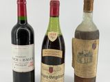three bottles of wine sitting next to each other on a white surface