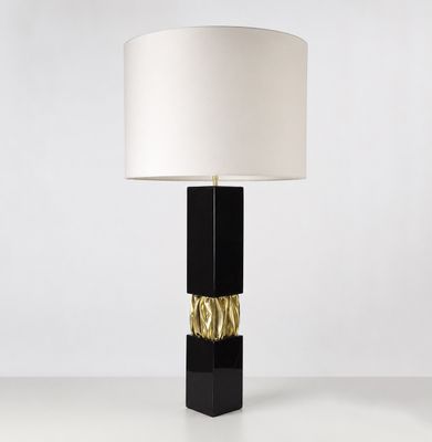 une lampe de table noire surmontée d'un abat-jour blanc