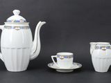 a white tea set with a cup and saucer