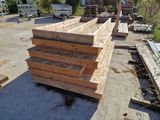 several pieces of wood are stacked on top of each other in a parking lot