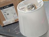 a trash can sitting on a table next to a cardboard box