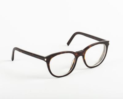 a pair of glasses sitting on top of a white surface