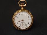 an antique pocket watch on a black background with a black background