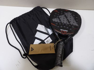 a tennis racket and a bag on a table
