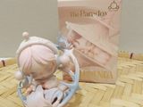 a small figurine of a girl on a rocking horse