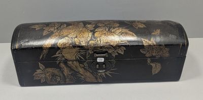 a black and gold box with flowers on it