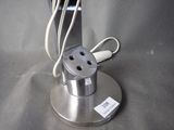 a metal device that is plugged into a metal stand
