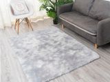 grey shaggy rug in a living room with a couch and a chair
