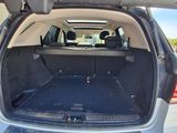 the back of a car with its trunk open and the back seats folded down