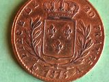 an old coin with a crown on it sitting on a green surface